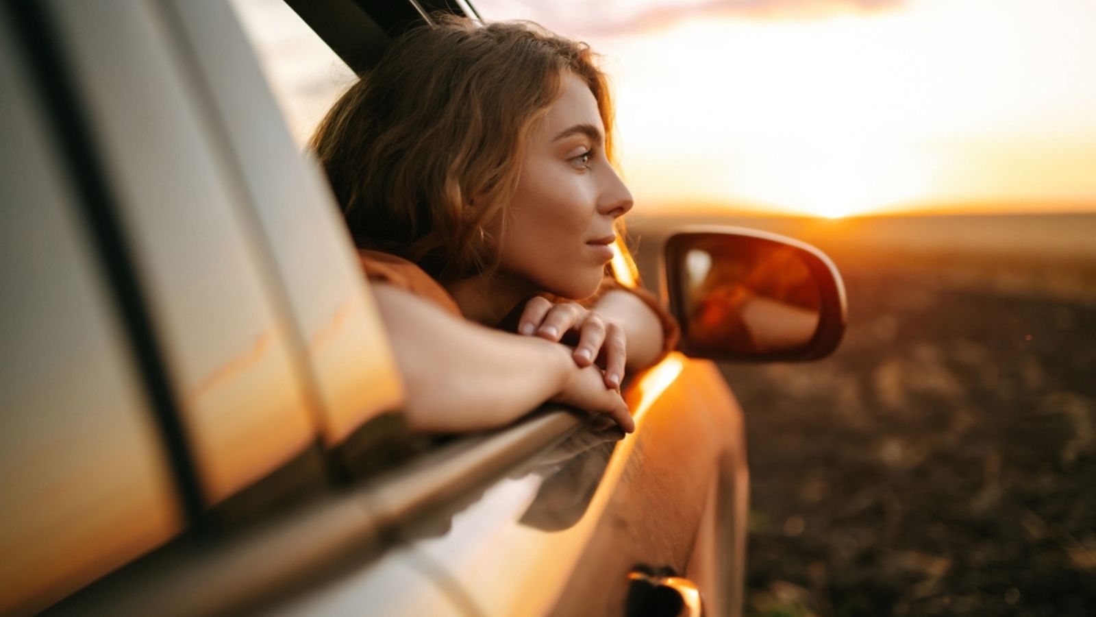 woman car drive sunset